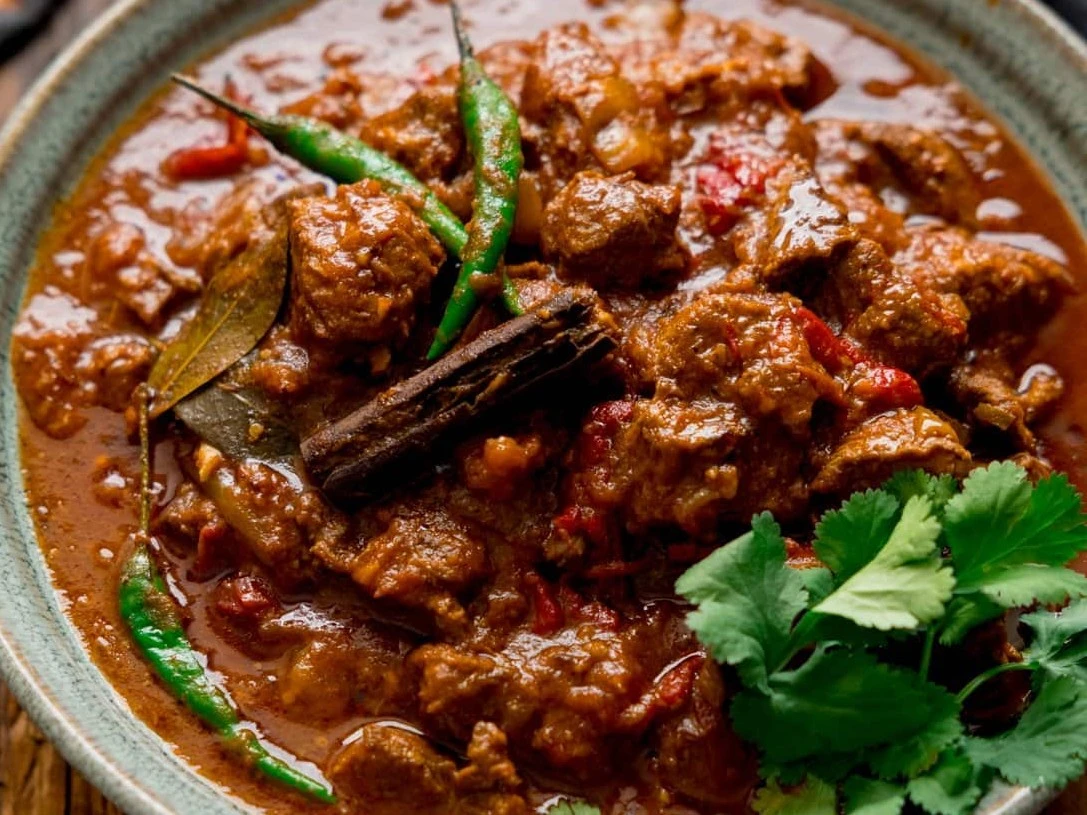Lamb Bhoona - Slow-cooked lamb curry with deep complex spices at Royal Heritage Calgary