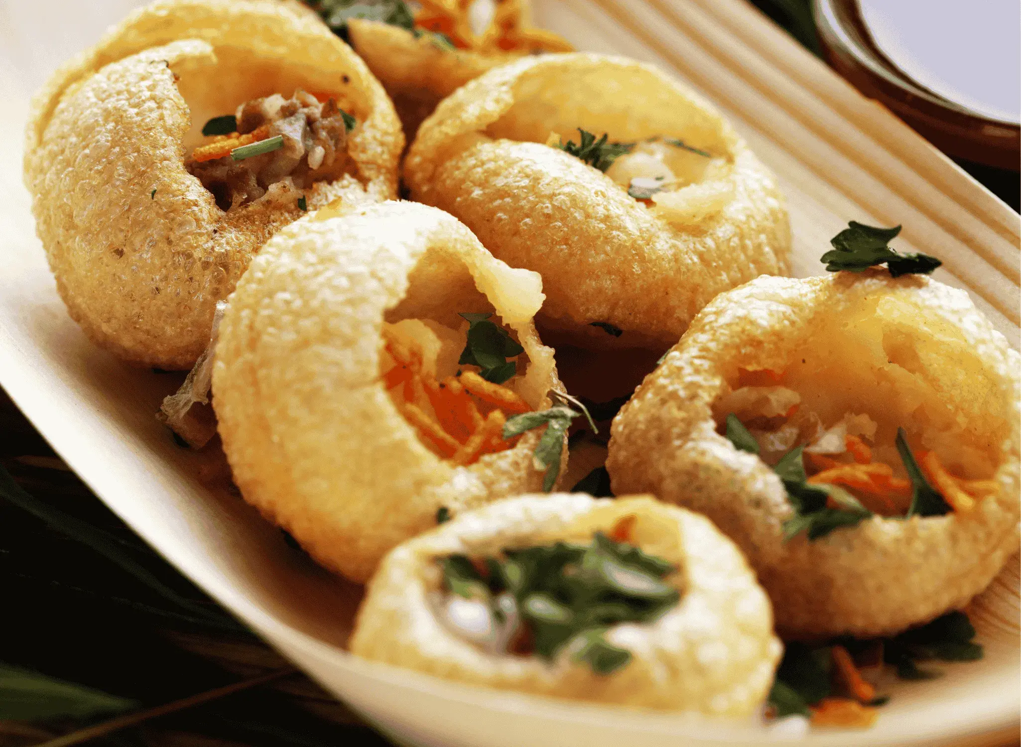 Pani Puri - Crispy street food appetizer with spiced potatoes and tamarind water at Royal Heritage Calgary